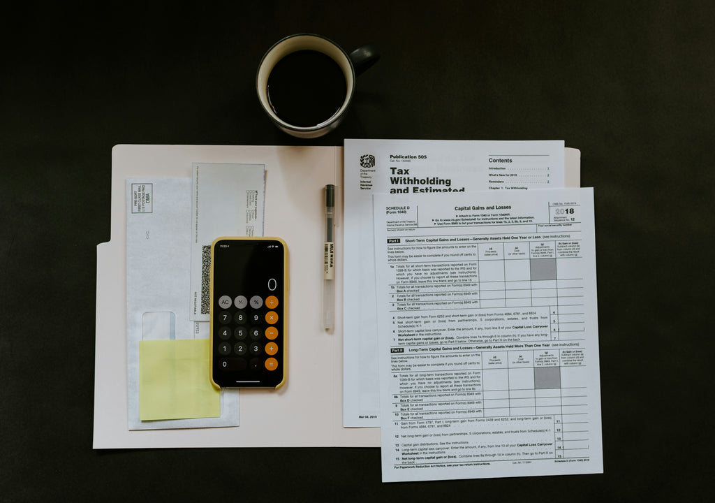 Tax documents, a calculator, and a cup of coffee in a layflat image