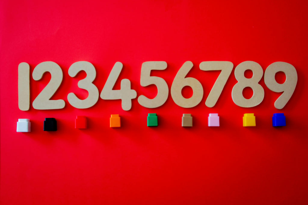 Numbers 1-9 on a red background with a single colored cube under each