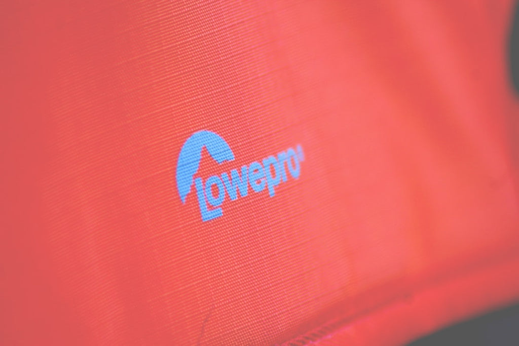 Close-up of red fabric with a blurred company logo for brand promotion.