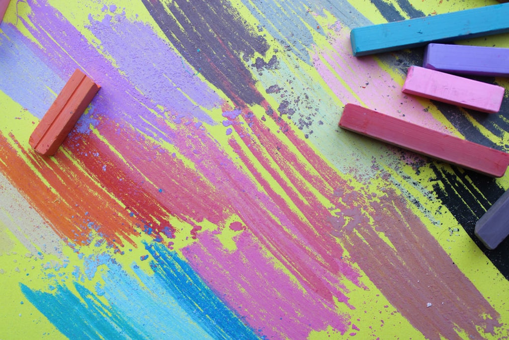 Colorful chalk sticks on a vibrant background, suggesting creative swag ideas.