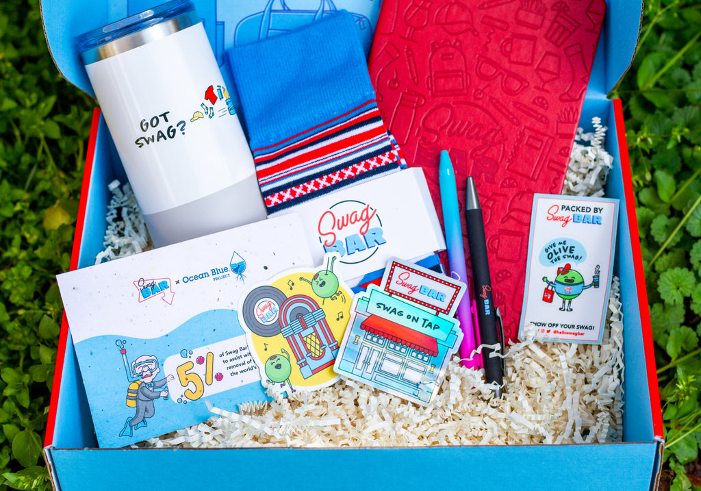 An open box of branded swag with a cohesive and colorful mix of items.